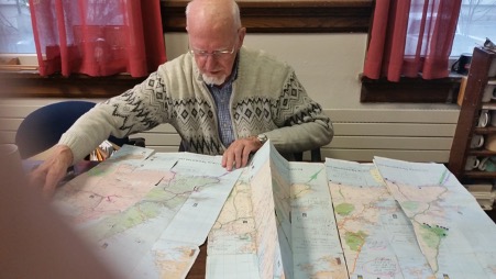 Harold sitting with maps